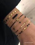 Ornament armbandje met zwarte koordjes